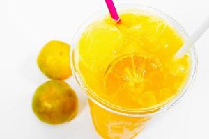 Slush ice with orange in Plastic Cup on background. photo