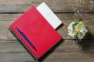 closeup note book on wood background photo