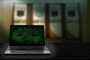 Computer with binary codes from monitor with Automatic Teller Machine blur background photo
