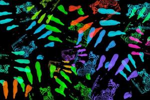 Abstract colorful handprint isolated on black background photo