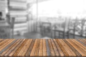 Empty wooden board space platform with blur restaurant background photo