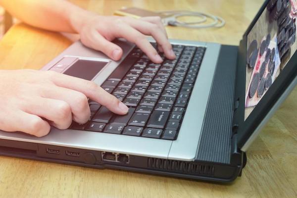 closeup man using notebook on wooden table,business concept