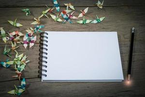 Light at the end of a pencil on open note book photo