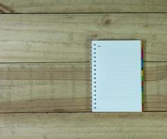 open note book on wooden background photo