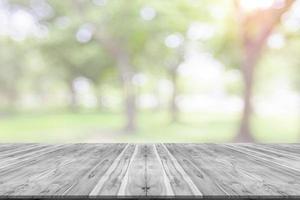 Empty wooden board space platform with natural bokeh blurred photo