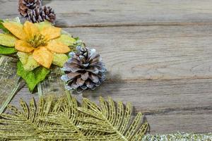 pine cones and gold leaf on the wooden board,christmas background photo