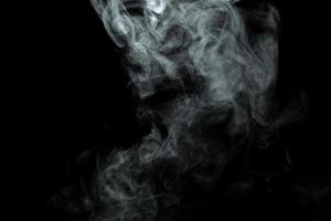 Abstract powder or smoke isolated on black background photo