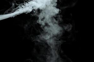 Abstract powder or smoke isolated on black background photo