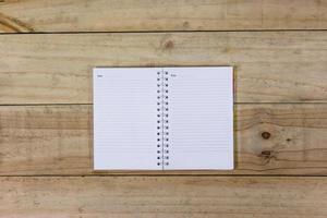 open note book on wooden background photo
