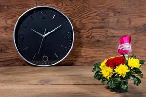 Colorful Bouquet with clock on wood background photo