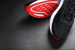 Black running shoes with mesh and black laces close-up on a dark background photo