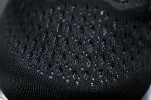 Mesh of black sports sneakers for training Macro photo