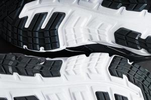 The sole of the sports sneakers for running in black and white close-up photo