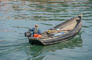 SCARBOROUGH,  NORTH YORKSHIRE, UK - JULY 18. Man in small fishing boat in Scarborough, North Yorkshire on July 18, 2022. Unidentified man photo