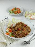 Fried rice with sausage and vegetables, cucumber, carrots, crackers photo