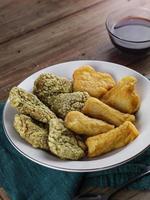 Pempek slices and vinegar sauce in a bowl. Pempek, mpek-mpek or empek-empek is a savory Indonesian fish cake delicacy, made from fish and tapioca, from Palembang, South Sumatra, indonesia photo