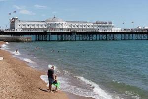 Brighton, East Sussex, UK - July 15, 2022. View of the beach and pier in Brighton on July 15, 2022. Unidentified people photo