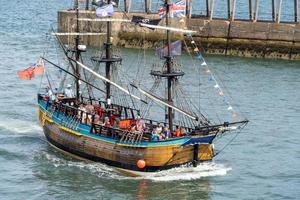 WHITBY,  NORTH YORKSHIRE, UK - JULY 19. Replica galleon pleasure boat heading into Whitby, North Yorkshire on July 19, 2022. Unidentified people photo