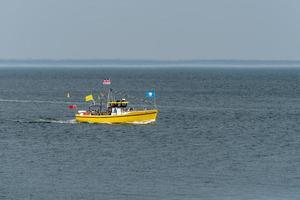 WHITBY,  NORTH YORKSHIRE, UK - JULY 19. Pleasure boat heading towards Whitby, North Yorkshire on July 19, 2022. Unidentified people photo