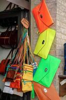 PIENZA, TUSCANY, ITALY - MAY 19. Brightly coloured bags for sale in Pienza on May 19, 2013 photo