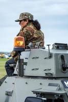 SHOREHAM-BY-SEA, WEST SUSSEX, UK, 2014. Soldier sitting on an amoured car at the Wartime re-enactment at Shoreham Airshow on August 30, 2014 photo