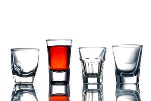 Collage of glasses with alcohol on a white background. photo