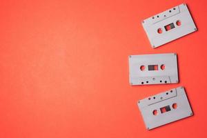 Audio cassette tapes on a orange background. Free space for text photo