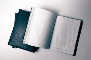 Top view of an open notebook on white background. Vintage tone photo