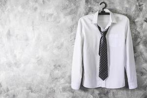 White shirt with long sleeves and necktie on grunge background. Free space for text photo