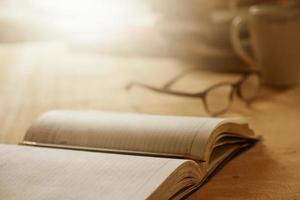 Close up of open notebook with pencil on wooden desk, Soft focus,  Flare sun light,Vintage tone.