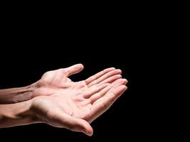 Male hands on a black background. Free space for text photo