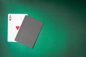 Playing card and back designs on green background. Free space for text photo