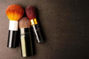 Makeup brushes on black background, Free space for text. photo