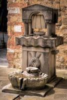 CASTIGLIONE DEL LAGO, PERUGIA OF UMBRIA,  ITALY - MAY 20. Drinking water fountain for people and animals in  Castiglione del Lago, Perugia of Umbria on May 20, 2013 photo