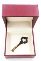 Metal key in red gift box on white background. photo