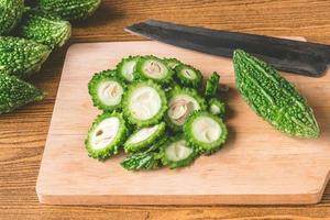 Bitter melon or bitter gourd on wooden tray. photo