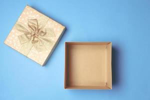 Top view of open gift box on blue background. photo