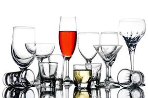 Collage of empty glasses with alcohol on white background. photo