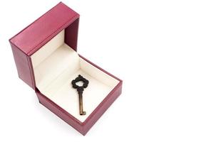 Metal key in red gift box on white background. photo