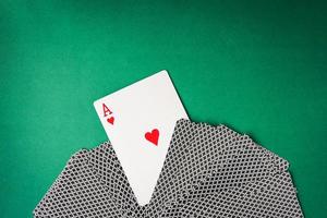 Heart ace with playing cards on green background. Free space for text photo