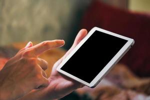 Close up of male hands using tablet computer touchscreen. photo