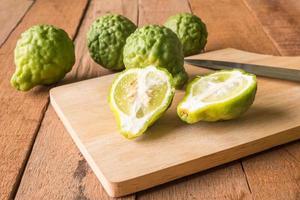 Close up of bergamot or kaffir lime on wooden table background. photo