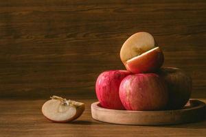 Red apples on the wooden table background. photo