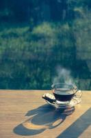 Cup of coffee on the table inside the window, coffee break in the morning with sunlight, relaxing and refreshing concepts. photo