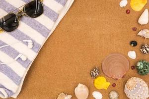 Top view of Travel accessories and Seashells on brown board background. photo