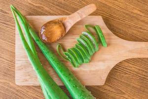 Top view of Aloe vera gel with aloe vera on wooden tray. photo