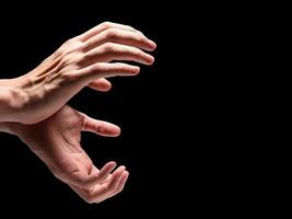 Male hands on a black background. Free space for text photo