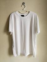 Blank t-shirt hanging on wall. photo