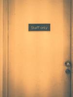 Staff only sign on a old door. Vintage tone photo