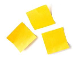 Yellow stick note paper on white background photo